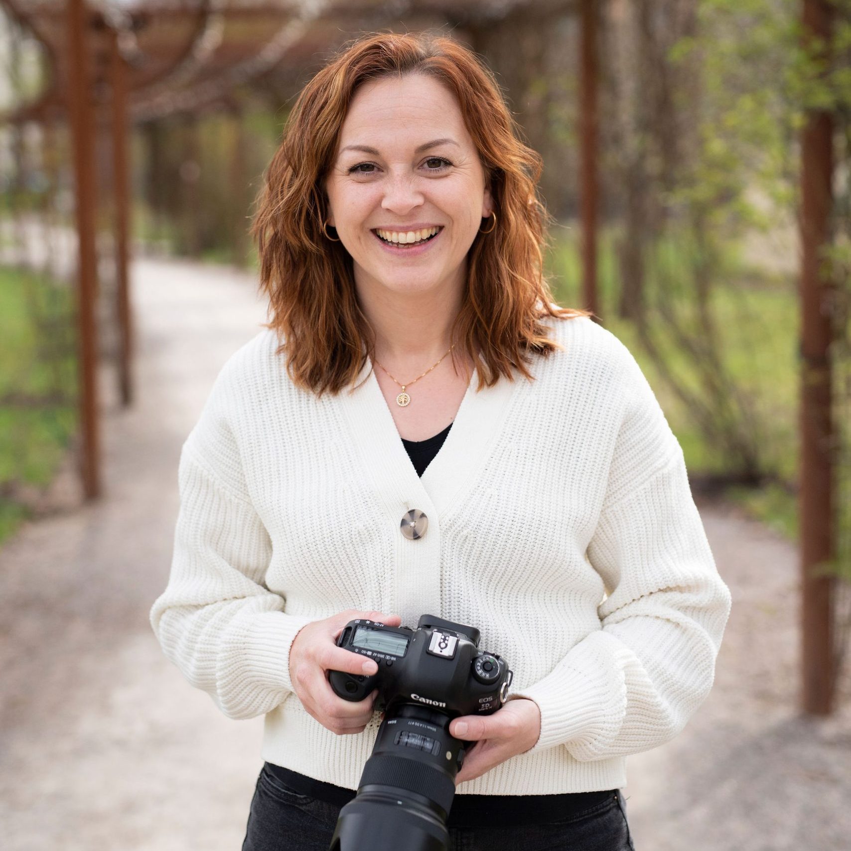 Glad fotograf med kamera i handen